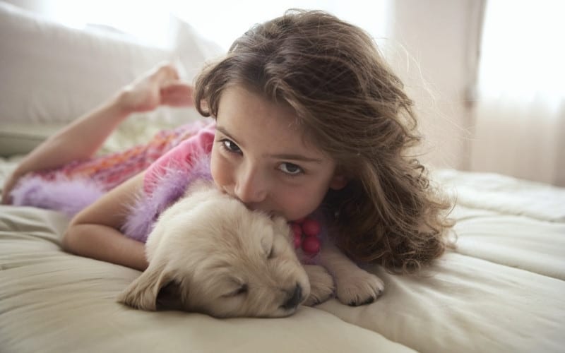girl in comfortable home with dog